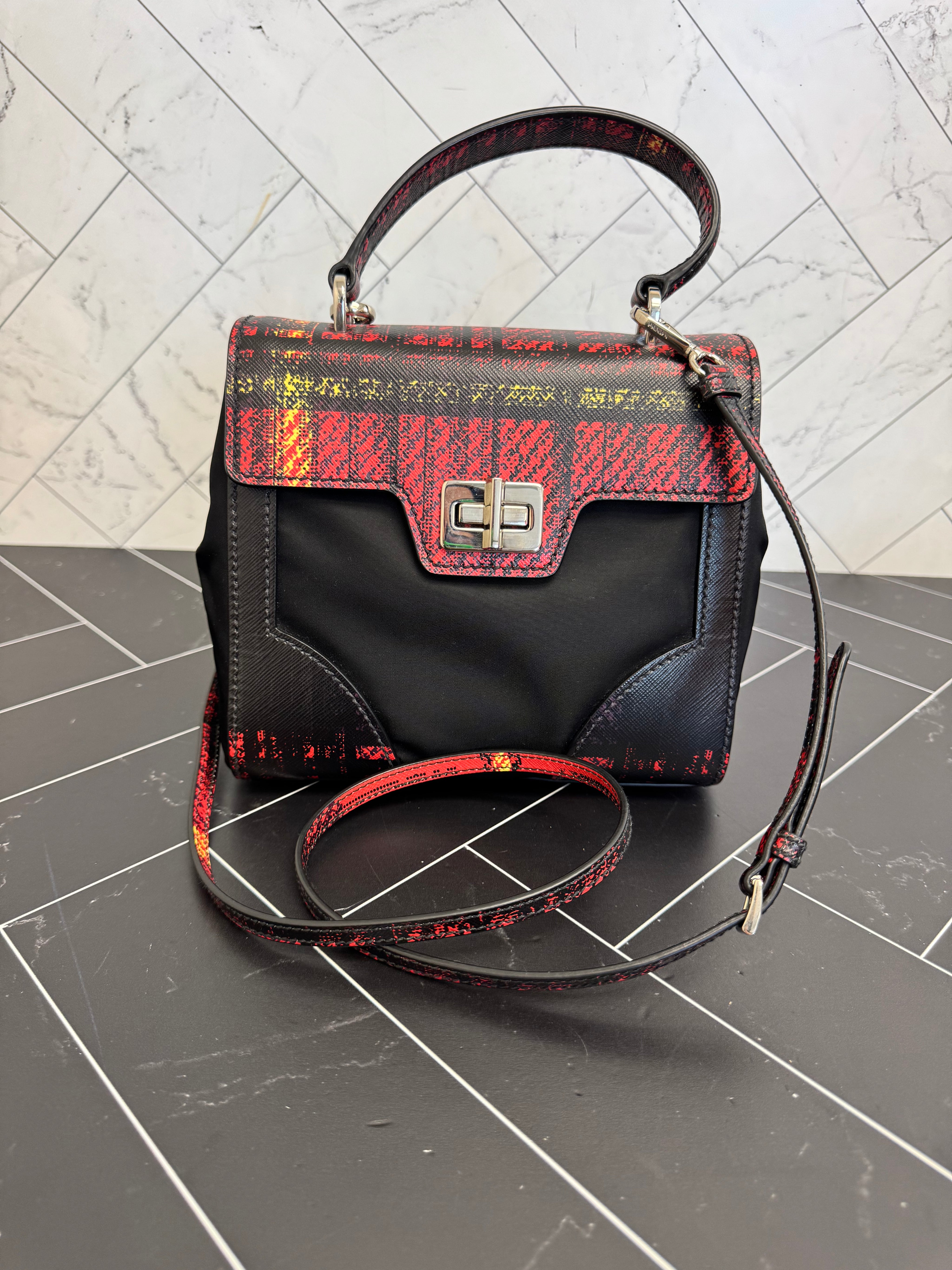 Prada Printed Saffiano Leather with Tessuto Small Turn Lock Top Handle Bag