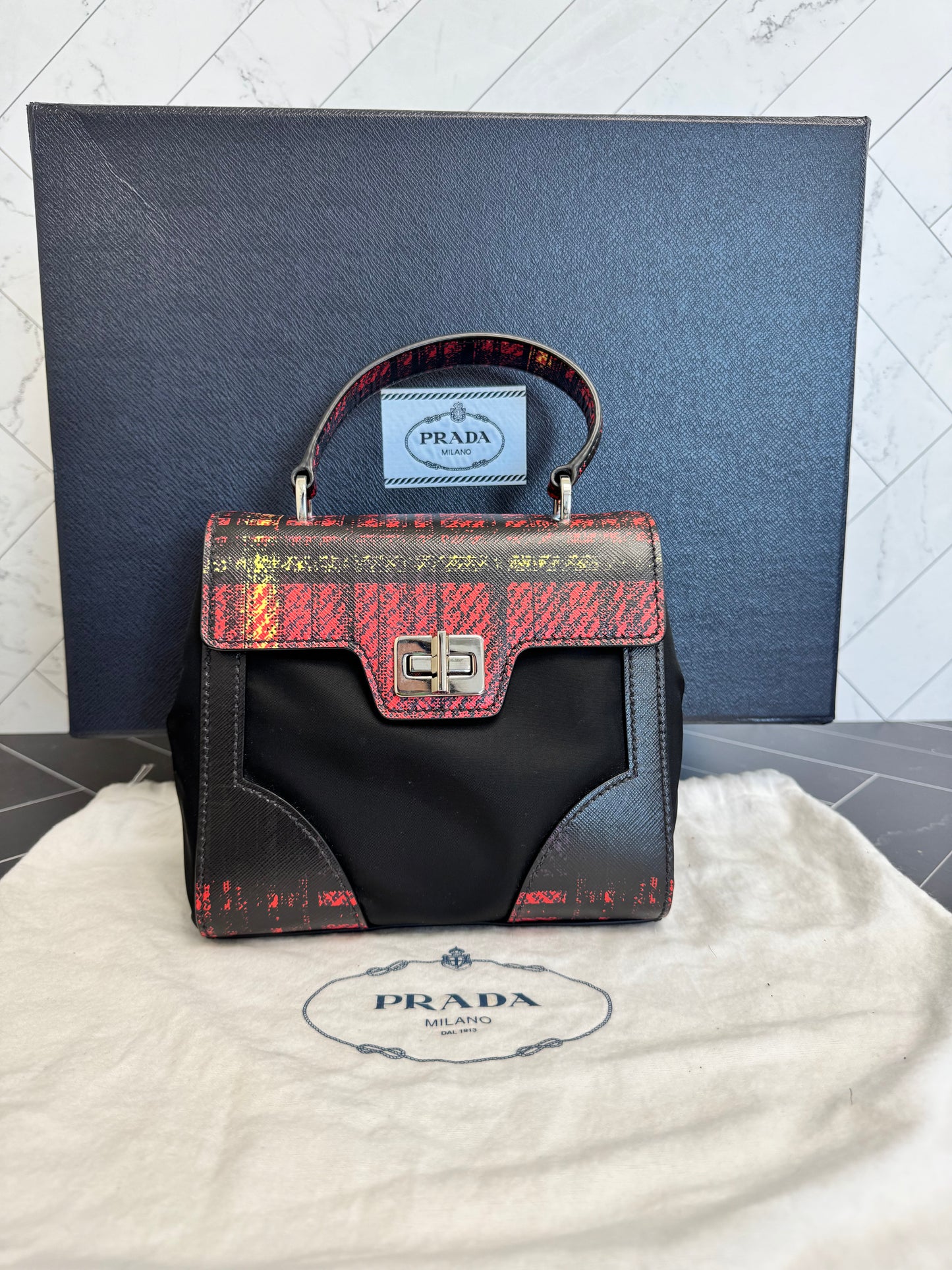 Prada Printed Saffiano Leather with Tessuto Small Turn Lock Top Handle Bag